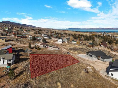 Aerial perspective of suburban area with property parcel outlined and mountains