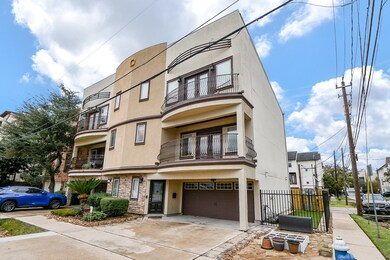 This modern three-story townhouse features a stucc