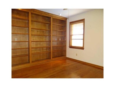 Den. FIRST FLOOR DEN  WITH BOOKSHELFS AND STORAGE