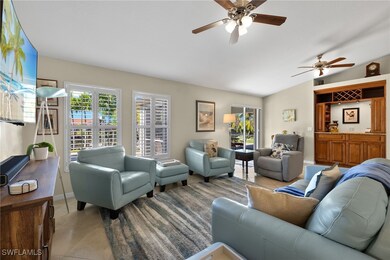 Tiled living room featuring lofted ceiling and ceiling fan