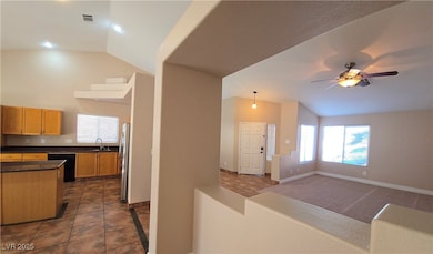 Kitchen with a sink, vaulted ceiling, black dishwa