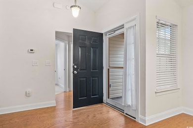 Foyer entrance with baseboards and wood finished floors