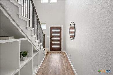 Bright foyer with a modern front door and shelving