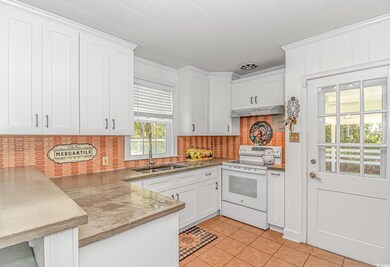 Kitchen featuring white range with electric stovet
