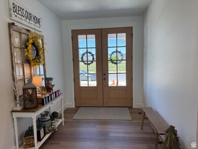 Foyer featuring french doors and wood finished floors