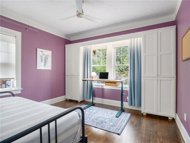 Bedroom with crown molding, dark hardwood / wood-s
