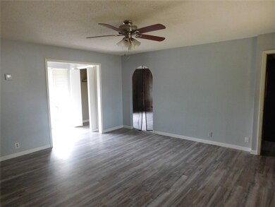 Looking across the living room toward the entryway and front door area.