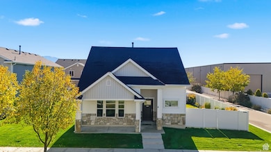 View of front facade featuring stone siding, board and batten siding, and a shingled roof