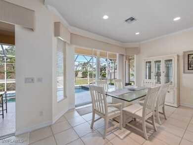 Dining space featuring ornamental molding, light t