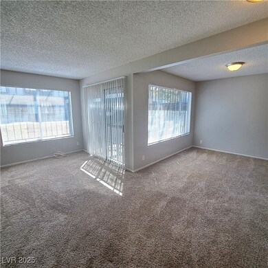 Empty room with baseboards, a textured ceiling, ca