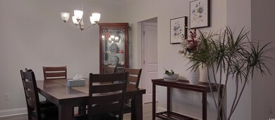Dining space with a chandelier and wood-type floor
