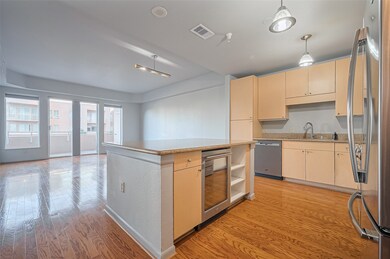 Spacious open-concept living area with hardwood fl
