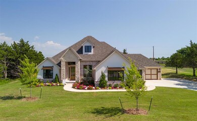 View of front of home with stone siding, concrete driveway, a front yard, and a garage