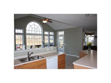 Vaulted Keeping room with wall of windows and door
