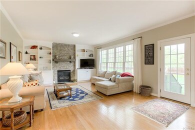 Lovely floor-to-ceiling stone fireplace is the cen