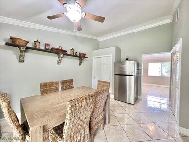 Tiled dining room with ceiling fan and ornamental