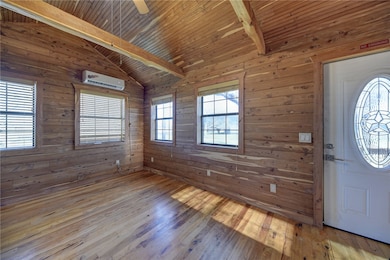 Foyer featuring plenty of natural light, lofted ce