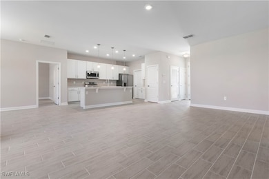 Unfurnished living room featuring light hardwood /