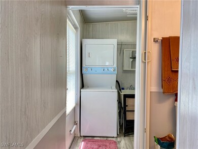 Laundry area with light hardwood / wood-style
flo