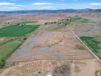 Aerial view of property's location with rural landscape, a mountainous background, and abundant farmland