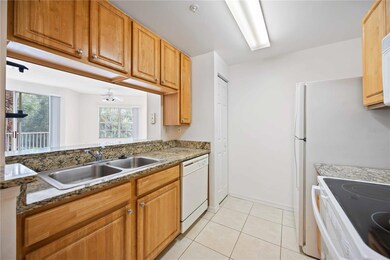 Kitchen features pantry, granite counters, ample cabinets.