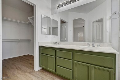Full bath with double vanity, wood finished floors
