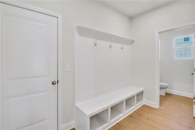 Mudroom featuring light wood-type flooring and baseboards