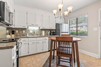 Kitchen featuring light tile patterned floors, app