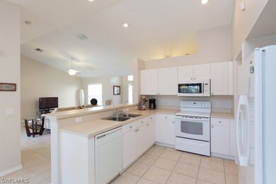 Kitchen view from breakfast area to living room