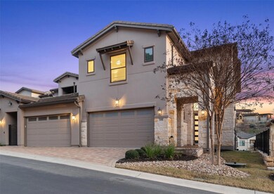 View of front of house with a garage, stone siding