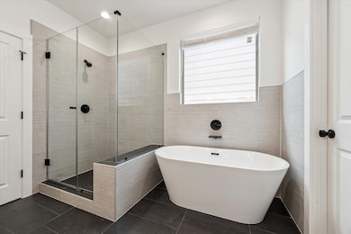 Spacious standalone shower and a spa-like soaking