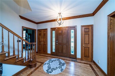 Foyer with Hardwood Floor and Crown Molding