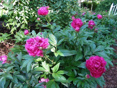 Lovely peonies convey with this gorgeous home!