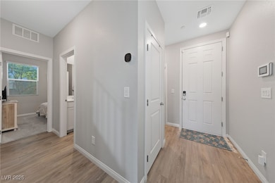 Hall featuring light wood finished floors