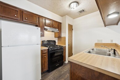 Kitchen with freestanding refrigerator, under cab
