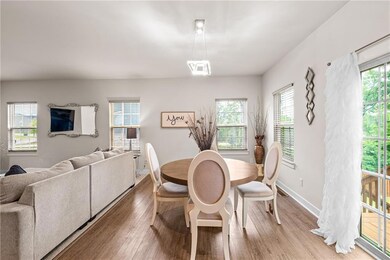 Dining space with light wood-style floors, plenty of natural light, and baseboards