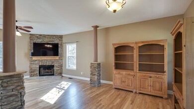 Custom interior features include oversized great room with stack stone pillars, new sand and finished hardwood floors, and eight foot ceilings. 