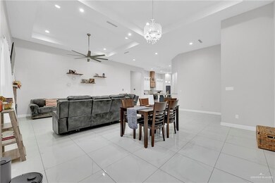 Dining room featuring ceiling fan with notable chandelier