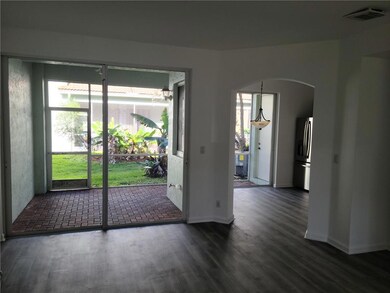 View from living room to screened patio & kitchen