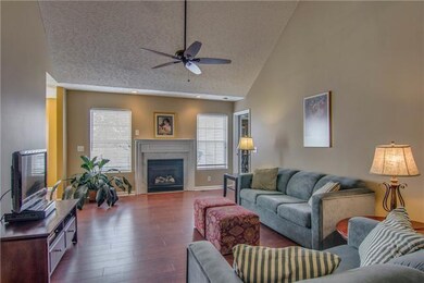 Enter into a large living room with vaulted ceilin