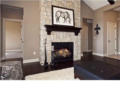 Stone fireplace with custom mantle and gas log sta