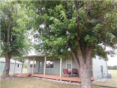 Front of property with mature Oak Trees