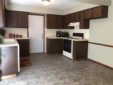 The large kitchen has new laminate flooring and op