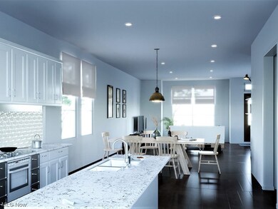 Kitchen with sink, hanging light fixtures, oven, tasteful backsplash, and white cabinetry
