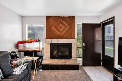 Living room featuring plenty of natural light, a tile fireplace, and tile patterned flooring