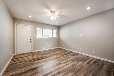 Spare room featuring baseboards, a ceiling fan, an