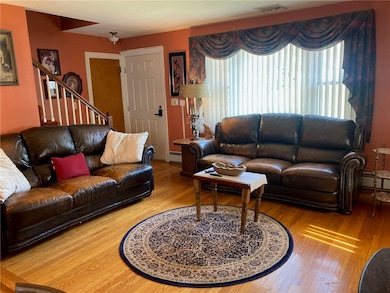 lining room with great natural light and hardwood
