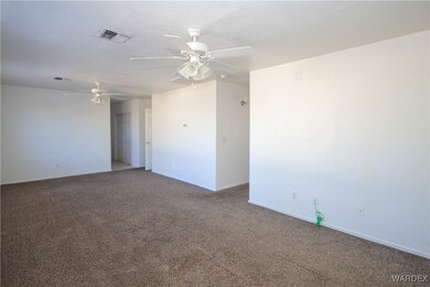 Spare room with ceiling fan and carpet floors