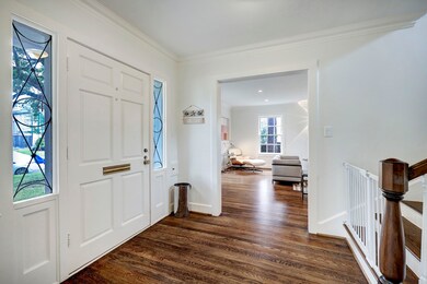 The large front door is flanked with leaded glass windows, giving you a nice view into the beautiful front yard. As you enter the home you will notice the beautiful, gleaming hardwood floors throughout!