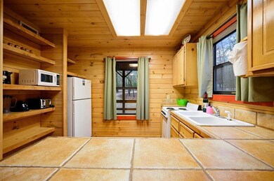 Kitchen featuring light brown cabinetry, tile coun